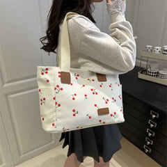 White corduroy tote bag with cherry print pattern