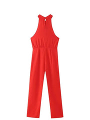 Chic red jumpsuit styled with handbag and heels