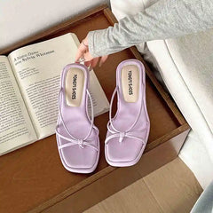 Casual purple wedge sandals styled with denim