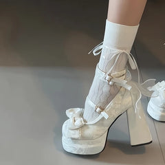 Chunky block heel party Mary Janes in white, shown for autumn fashion on a neutral background .
