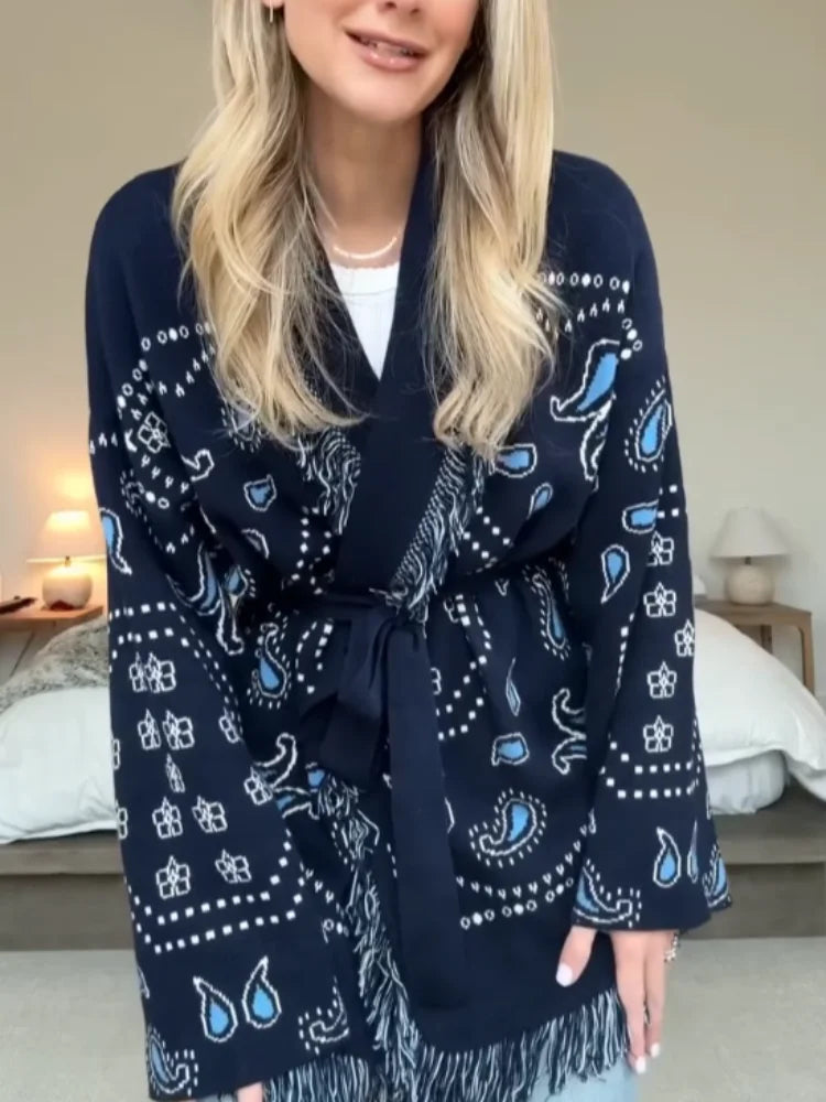 Person wearing a navy blue patterned robe in a bedroom setting
