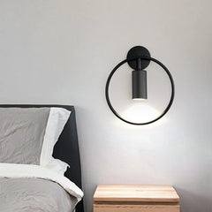 Circular metal wall sconce styled for hallway or gallery