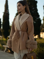 Chic camel coat worn as a formal outerwear piece in a snowy setting