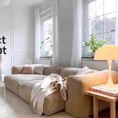 “Close-up of plush beige fabric cushions on sectional sofa”

