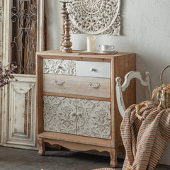 “Close-up of carved floral patterns on wood cabinet doors”
