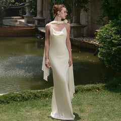 Close-up of satin neckline and pleated detail in apricot gown