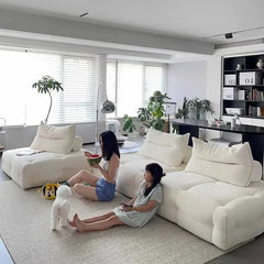 “Close-up of snowflake velvet fabric and cylindrical headrest on modular sofa”