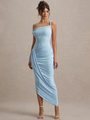 Woman wearing Close-up of waist ruching and soft fabric drape on maxi dress against a beige background