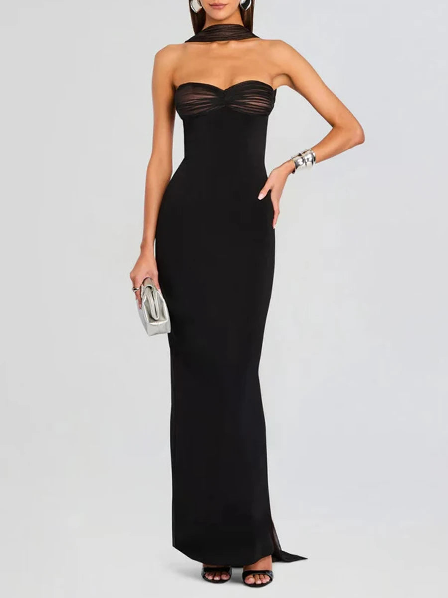 Floor-length column gown with natural drape and back detailing styled for premium evening occasions.