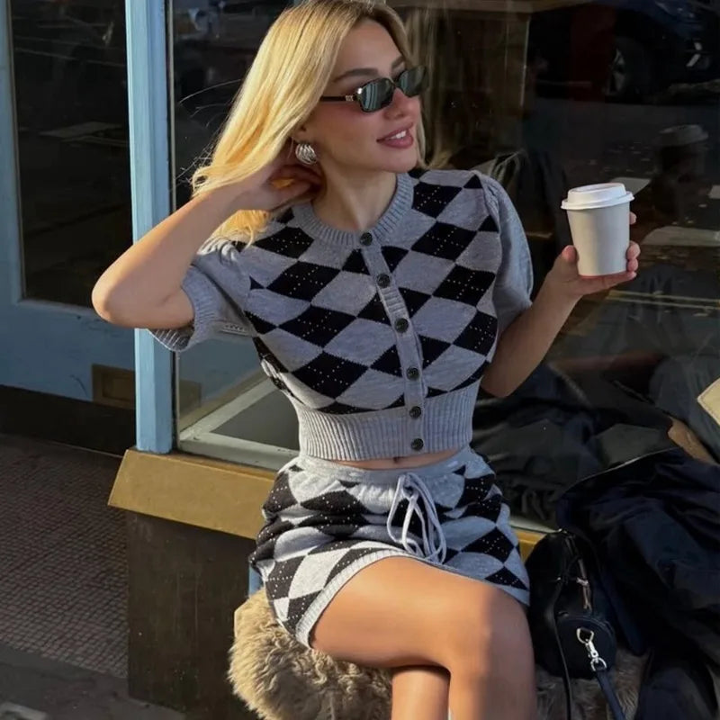 Coordinated cardigan and mini skirt set styled for a polished city look