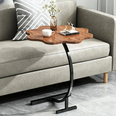 Compact accent table holding a notebook and a small vase