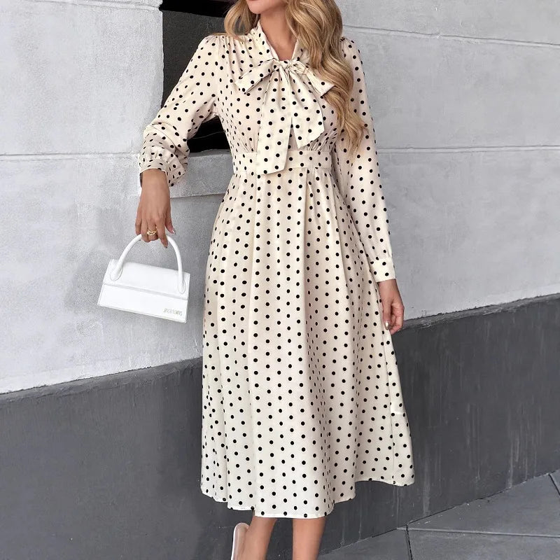 Long sleeve polka dot dress showing ankle-length hem and clean drape