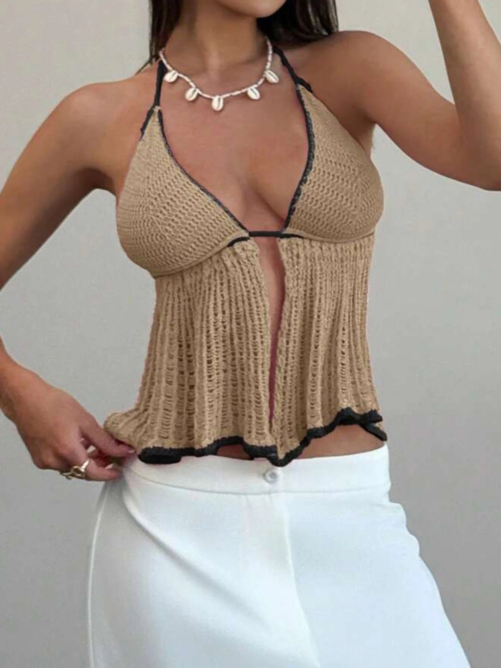 A close-up of the contrast trim and halterneck detail of the top.