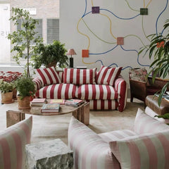 “Front view of cotton-linen striped couch with white pillows”