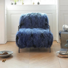 Modern cozy reading chair styled with rug and neutral wall