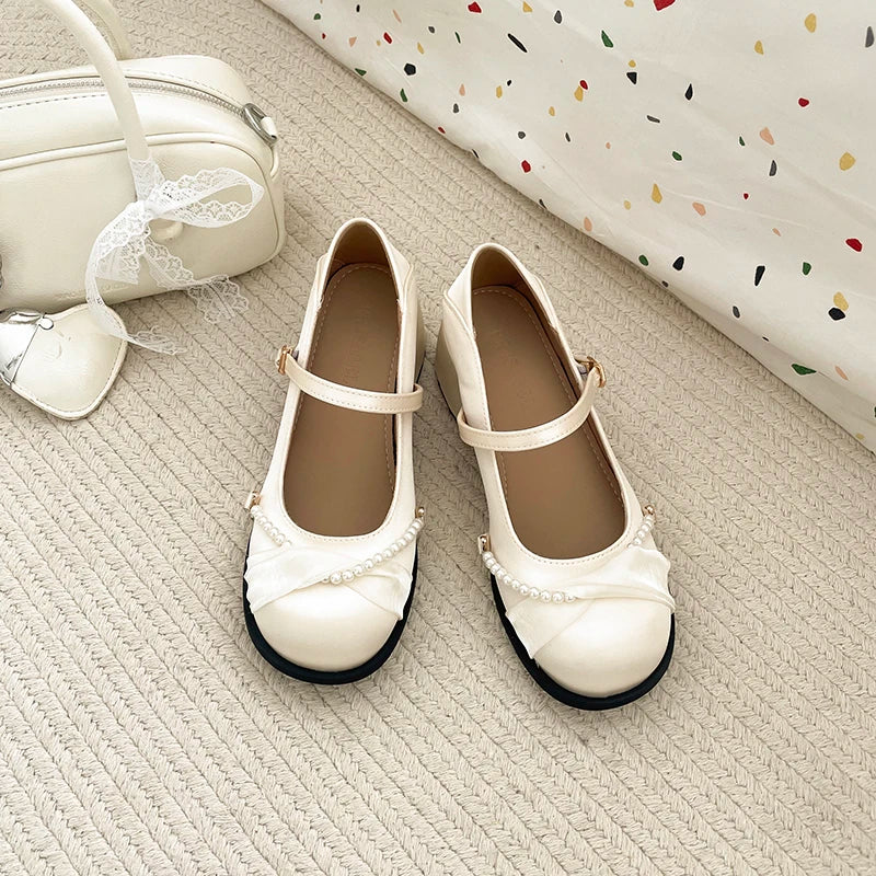 Pair of cream Mary Jane pumps with block heel
