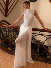 Mid-to-lower view showing the floral fold detail at the waist and the asymmetrical layered skirt fall in soft, airy fabric.