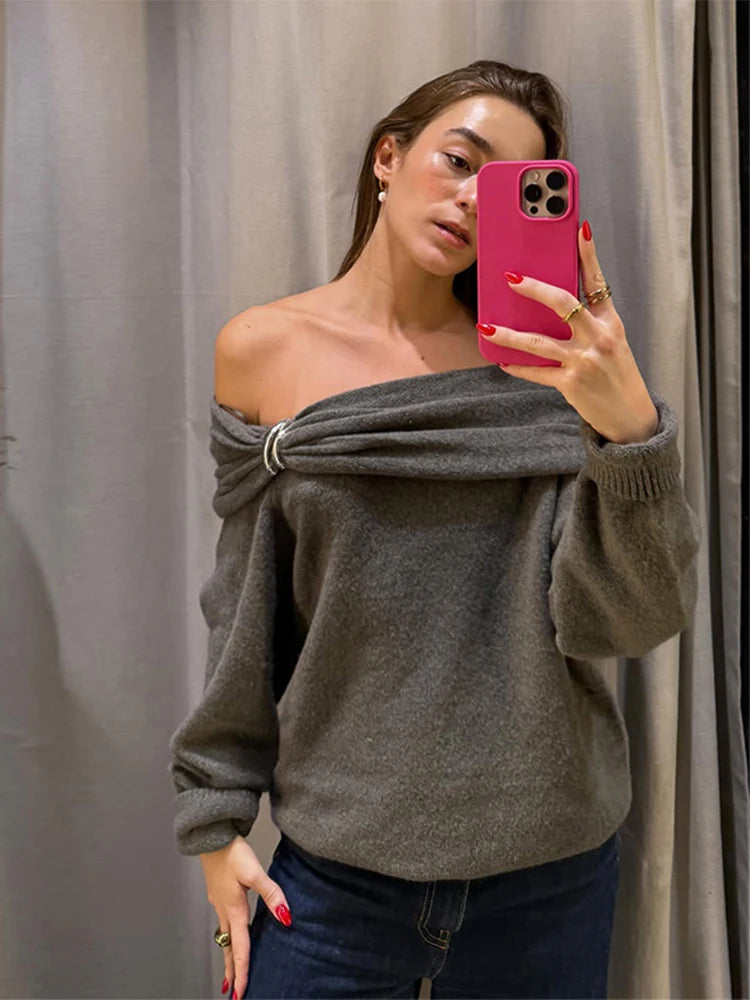 Long sleeve knit pullover styled as an off-shoulder top with short length