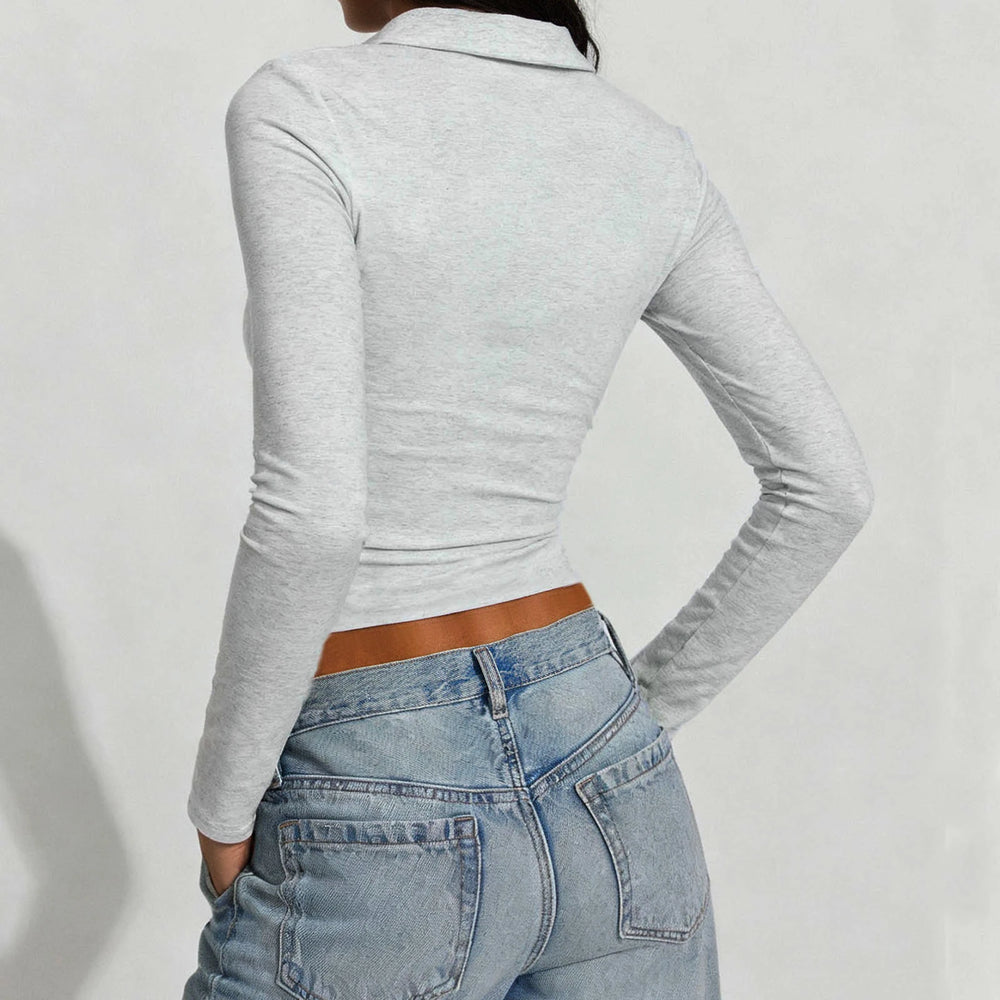 Back view highlighting the slim fit through the waist and long sleeve length.