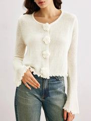 Cropped white floral cardigan styled over high-waisted jeans