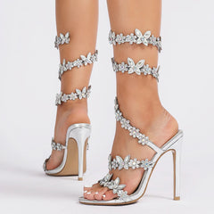 A woman wearing the crystal butterfly-knot heels with a formal dress at a wedding.