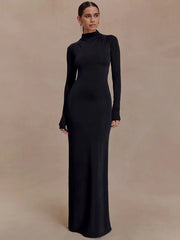 Full-length black evening dress with long sleeves and open back design