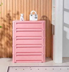 “Cute bedside cabinet styled in teen room with toys and decor”