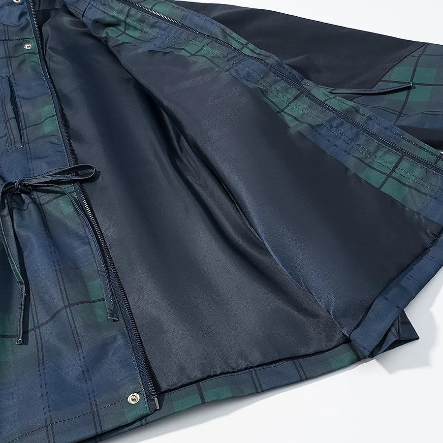 Close-up of a dark blue jacket with plaid pattern on a white background