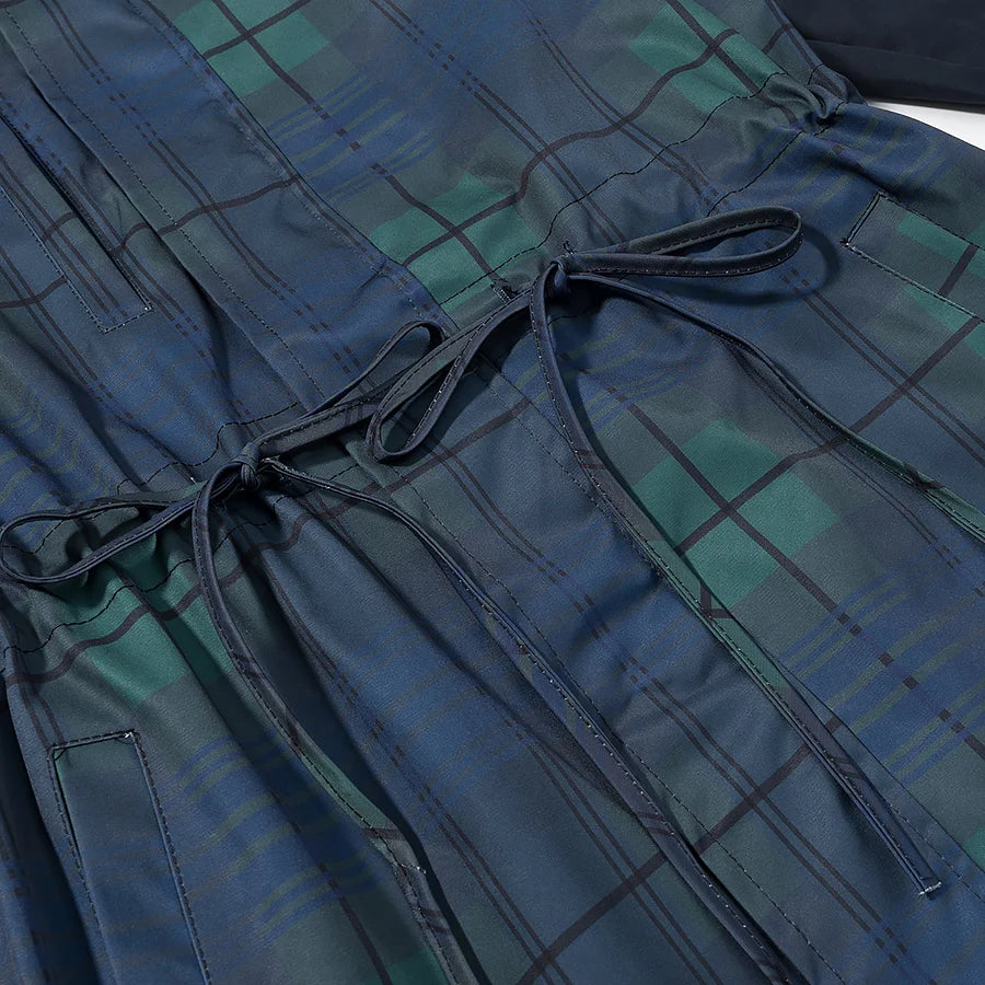 Close-up of a blue and green plaid garment with a drawstring.