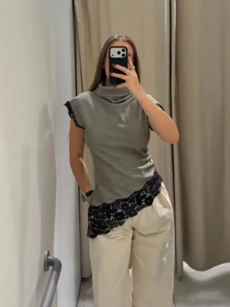 A fitted sleeveless stand-collar top styled for refined summer or indoor daytime wear.