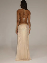 Cut-out gold maxi dress shown in a refined formalwear look.