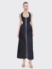Woman wearing a denim halter maxi dress with a clean zip down the front on a white background