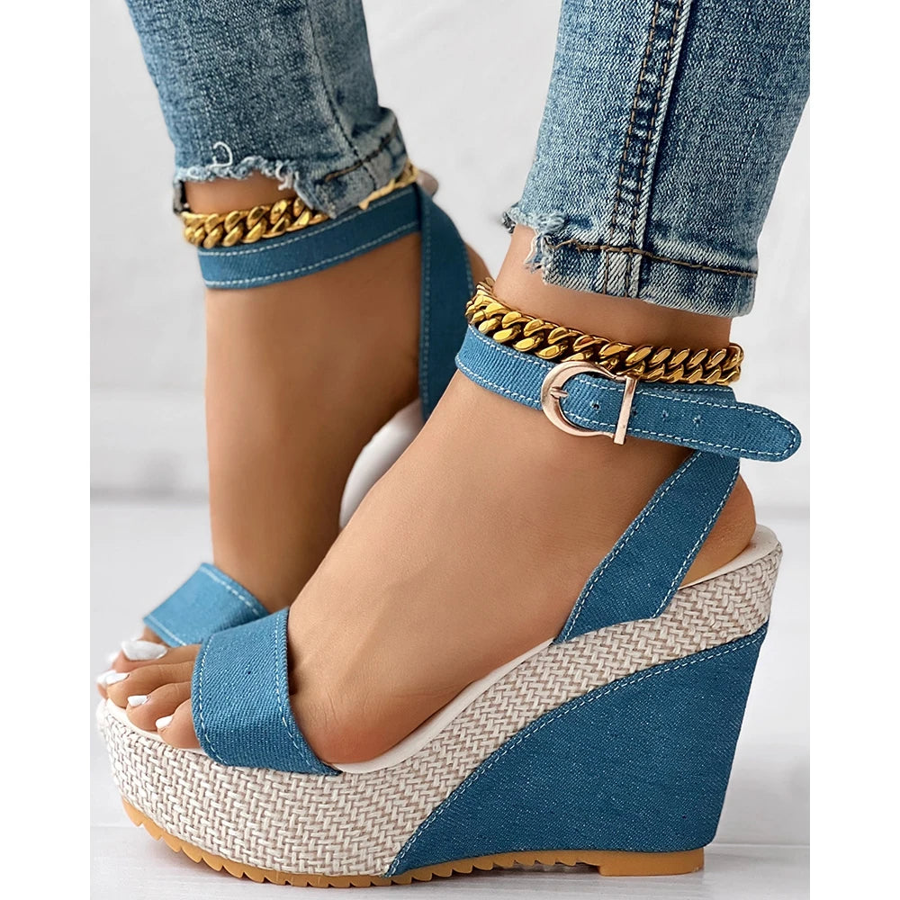 Blue denim ankle strap wedge sandals with buckle closure