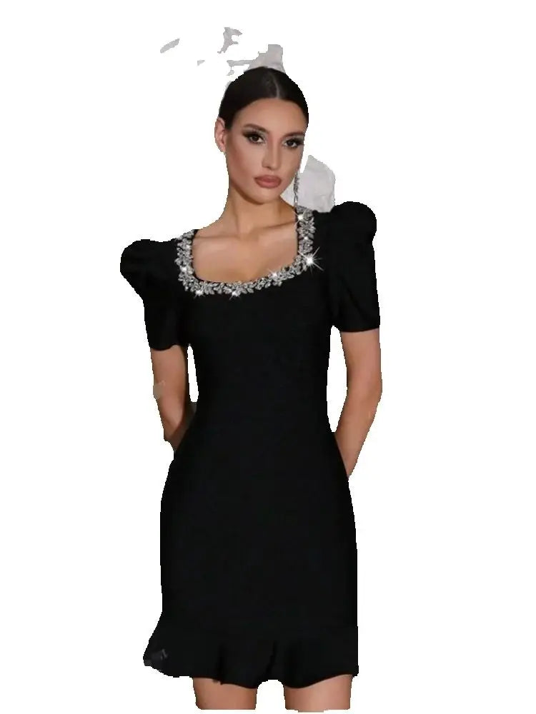 Black dress with decorative neckline on a white background