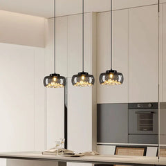 Dimmable black glass pendant trio over a modern kitchen island