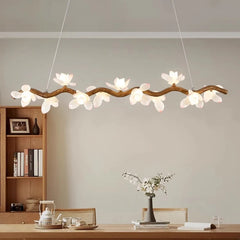 Dimmable floral branch chandelier above a modern dining table