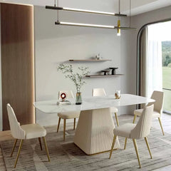 “Dining room setup with modern white and gold table and shelves”