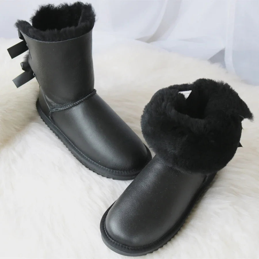 Black snow boots with double bow detail and faux fur lining