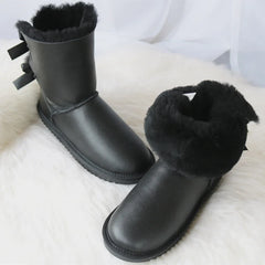 Black snow boots with double bow detail and faux fur lining
