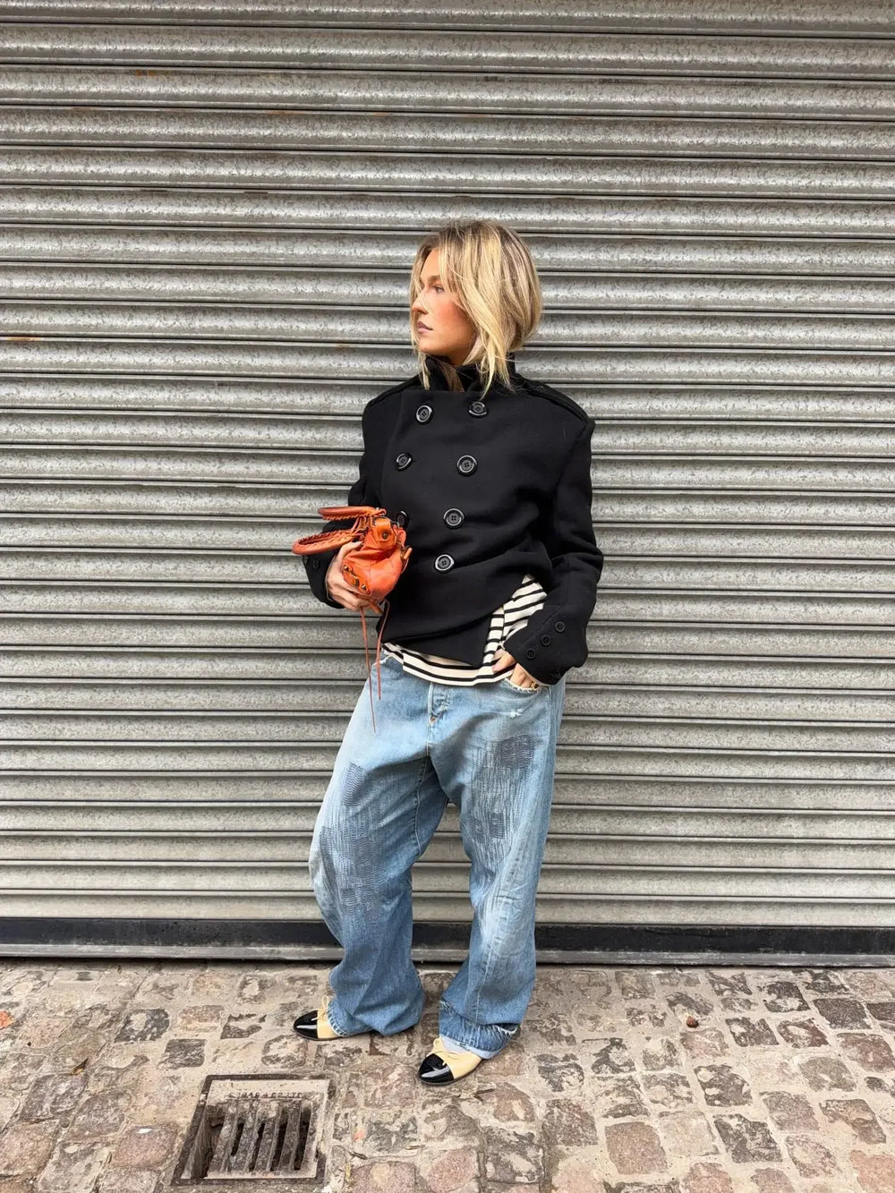 Close view of double-breasted button details on a short coat