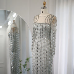 Dubai long sleeve formal party gown displayed in an elegant interior on a mannequin against a white curtain.