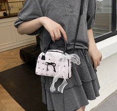 Crossbody pillow bag with feminine bow print design