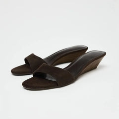 Elegant brown wedge heel slides on white background