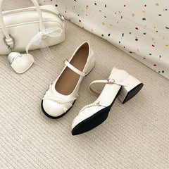 Elegant cream strap pumps on neutral background