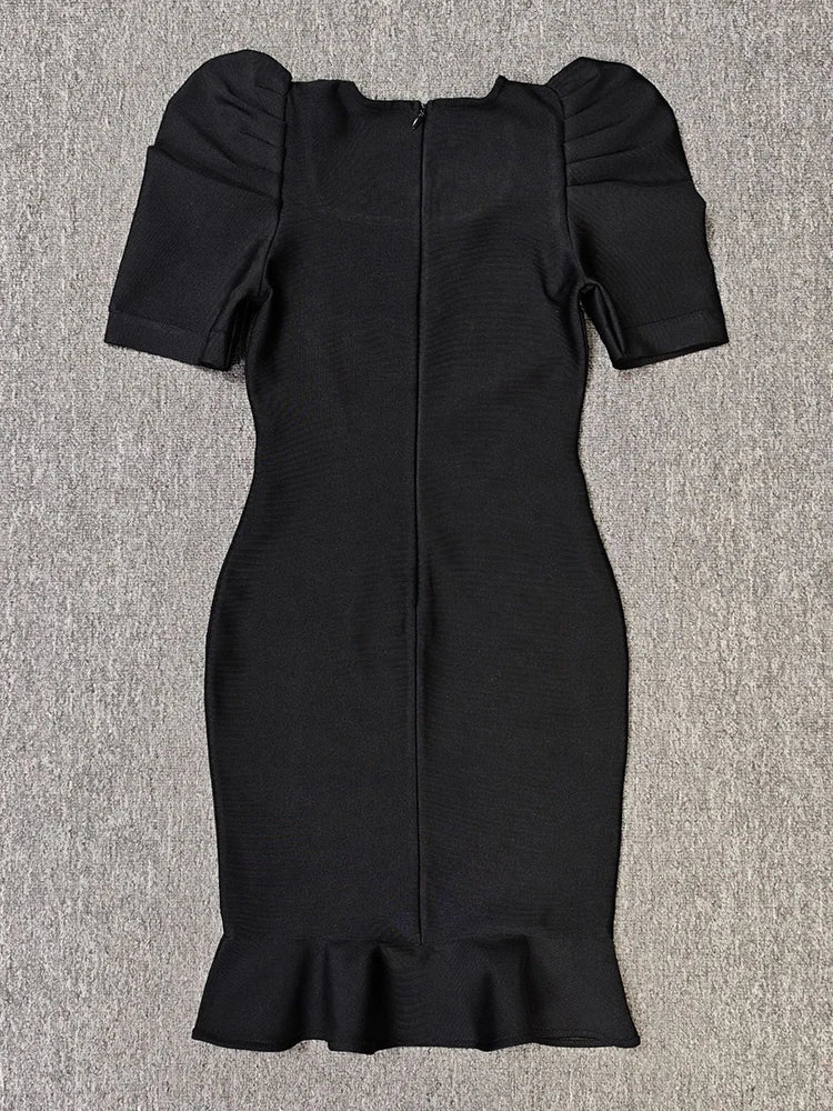 Black dress with puff sleeves on a gray background