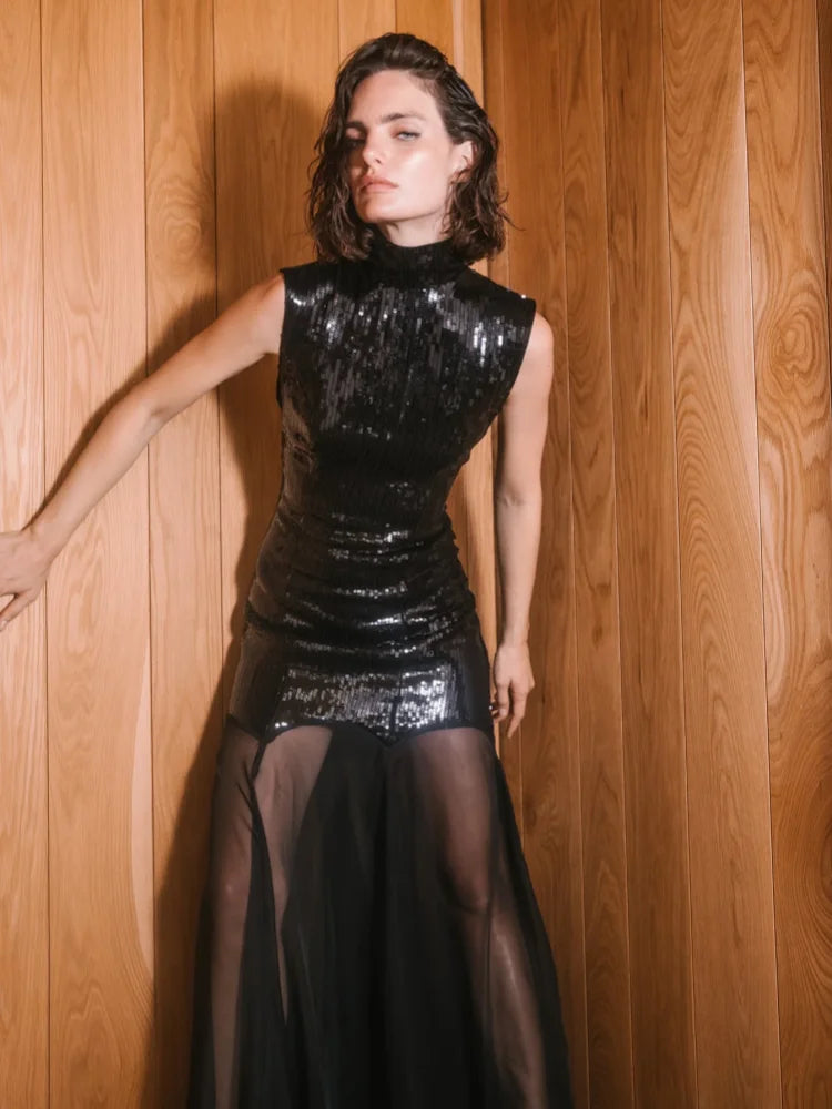 An elegant evening party gown styled with heels and a clutch.