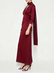 Full-length view of a maroon satin evening dress styled with heels.