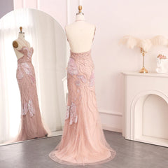 The full length of the elegant mermaid gown, styled for a formal event with the feather scarf.

