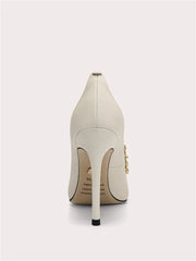 Close-up of pointed pearl wedding shoes with slim heel