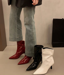 Trio of women’s pointed toe patent ankle boots in red, black, and white